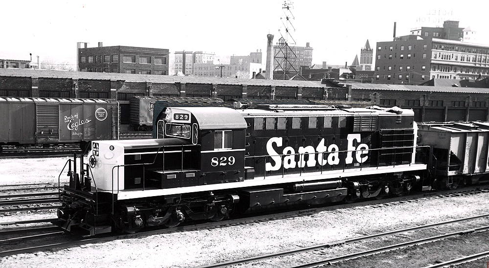 A santa fe train sitting in a rail yard