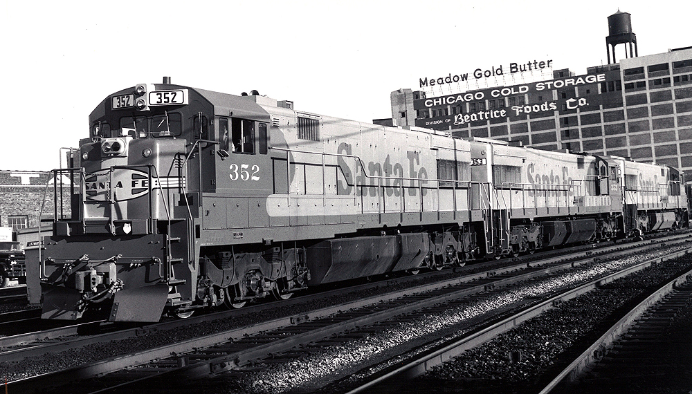 A santa fe train passing by a chicago cold storage building