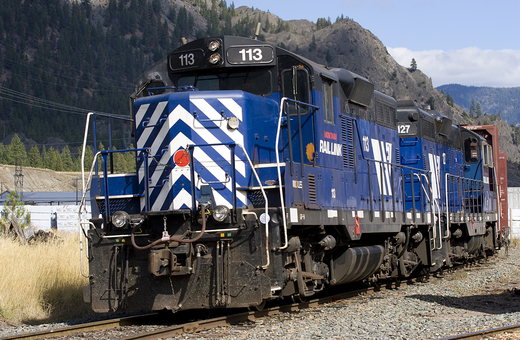 A blue and white train passing by