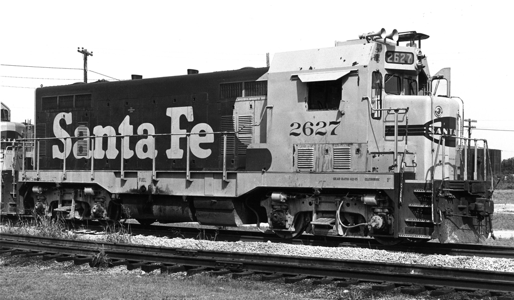A close up of a santa fe train on the tracks