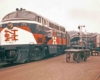 Diesel locomotive by station platform with baggage cart