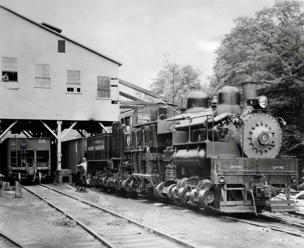 Oversize geared steam locomotives under coal loading tipple