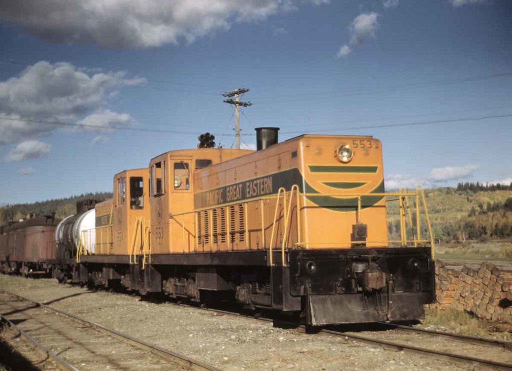 Orange-and-green GE 70-ton diesel locomotives with train