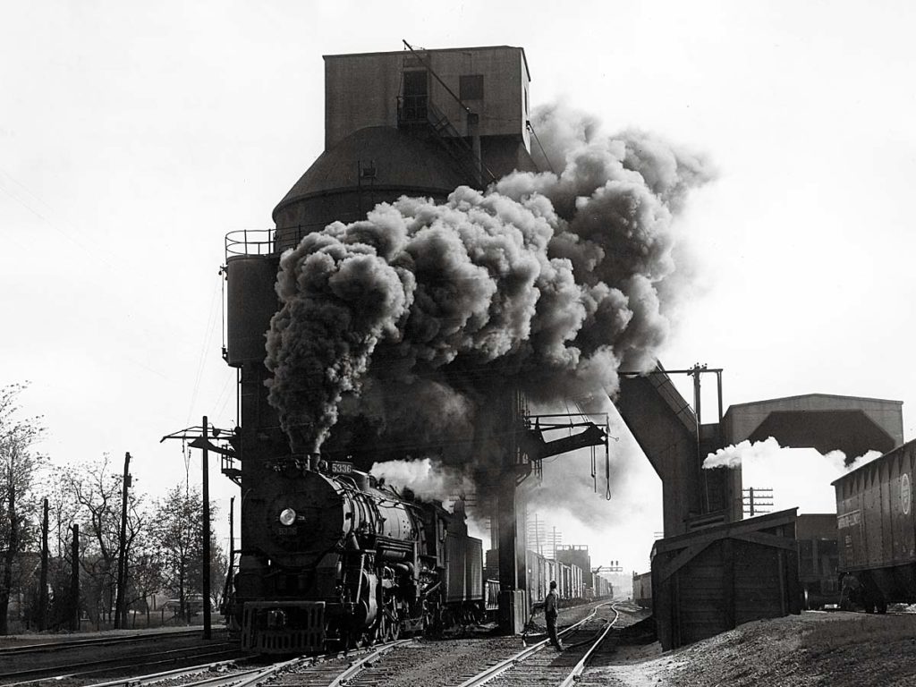Smoking steam Missouri Pacific locomotives with freight train