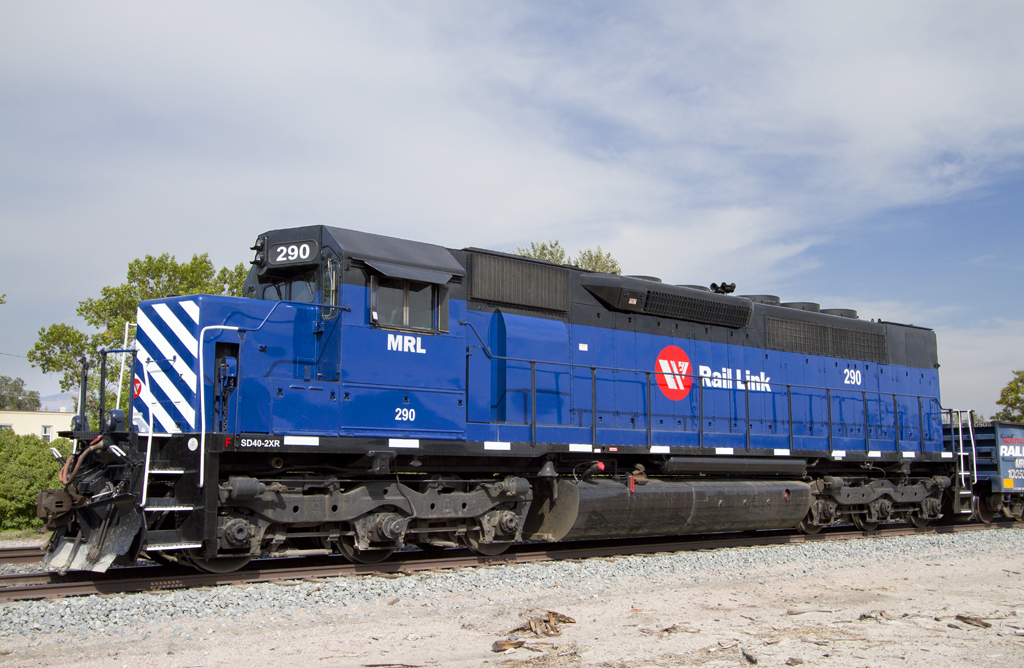 A blue train sitting on the tracks