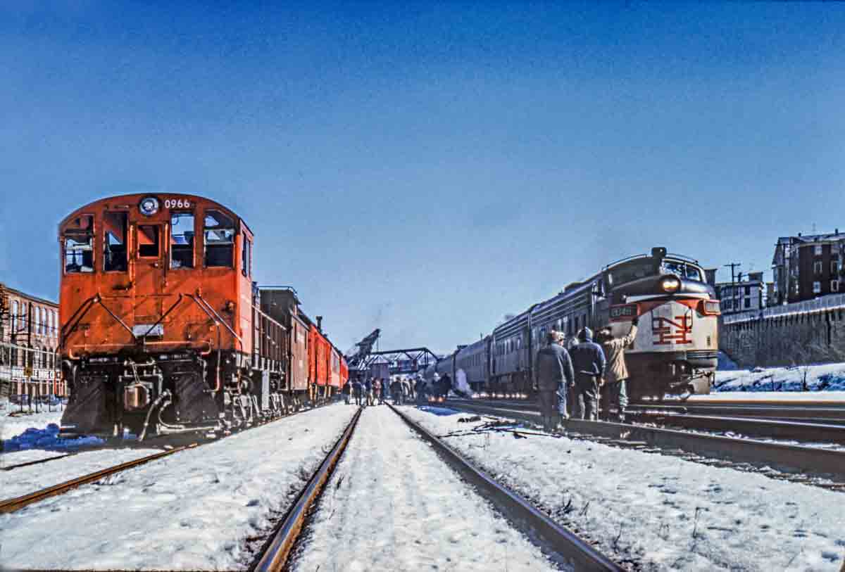 Diesel locomotives pass in snow