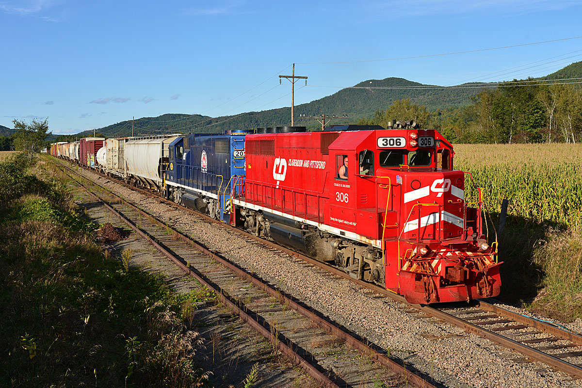 A train passing by with the conductor looking out the window