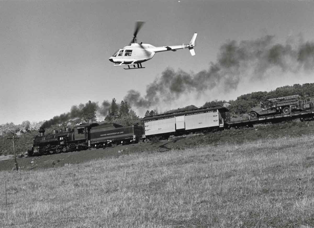 Helicopter paces steam locomotive and train