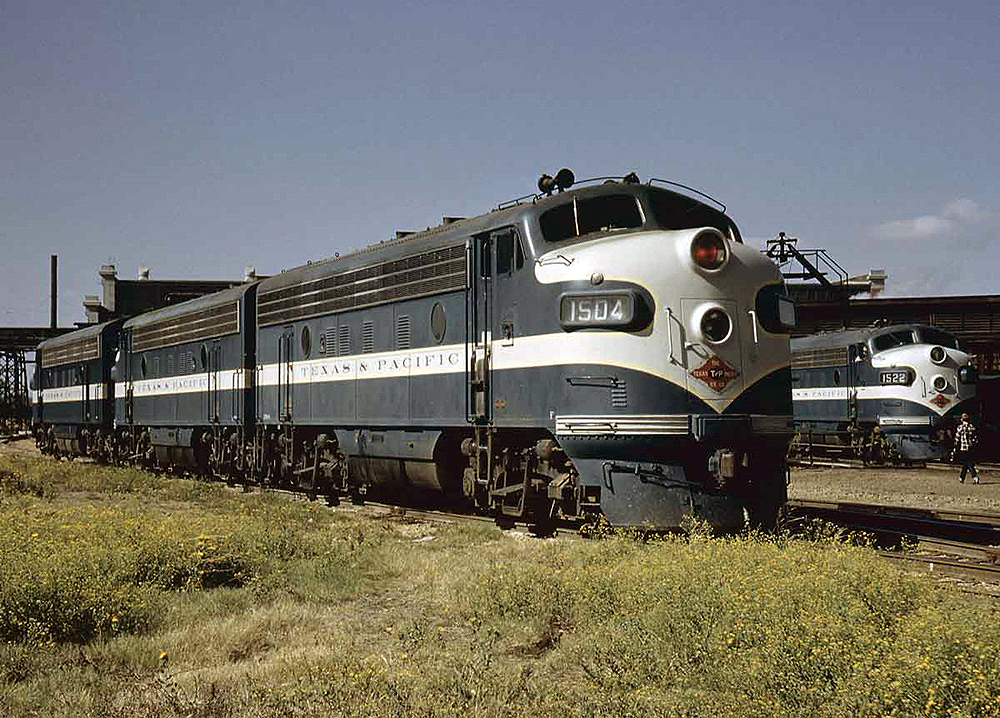 Two trains sitting outside a train station