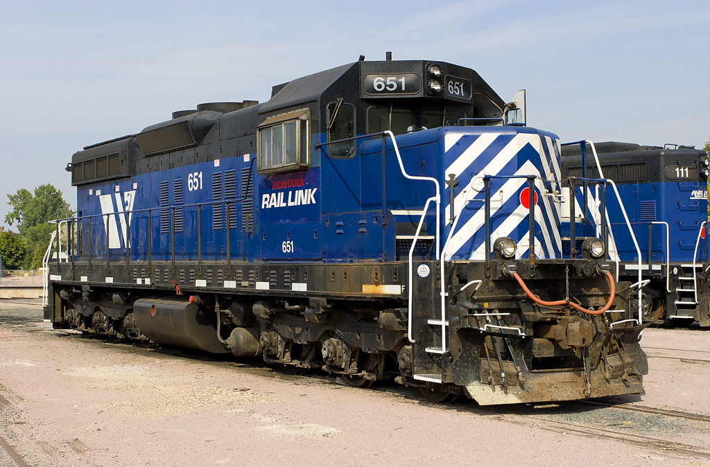 A blue train parked in a rail yard