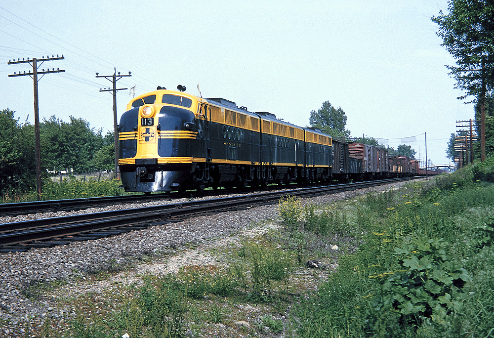 A yellow and navy blue FT diesel locomotive on the tracks