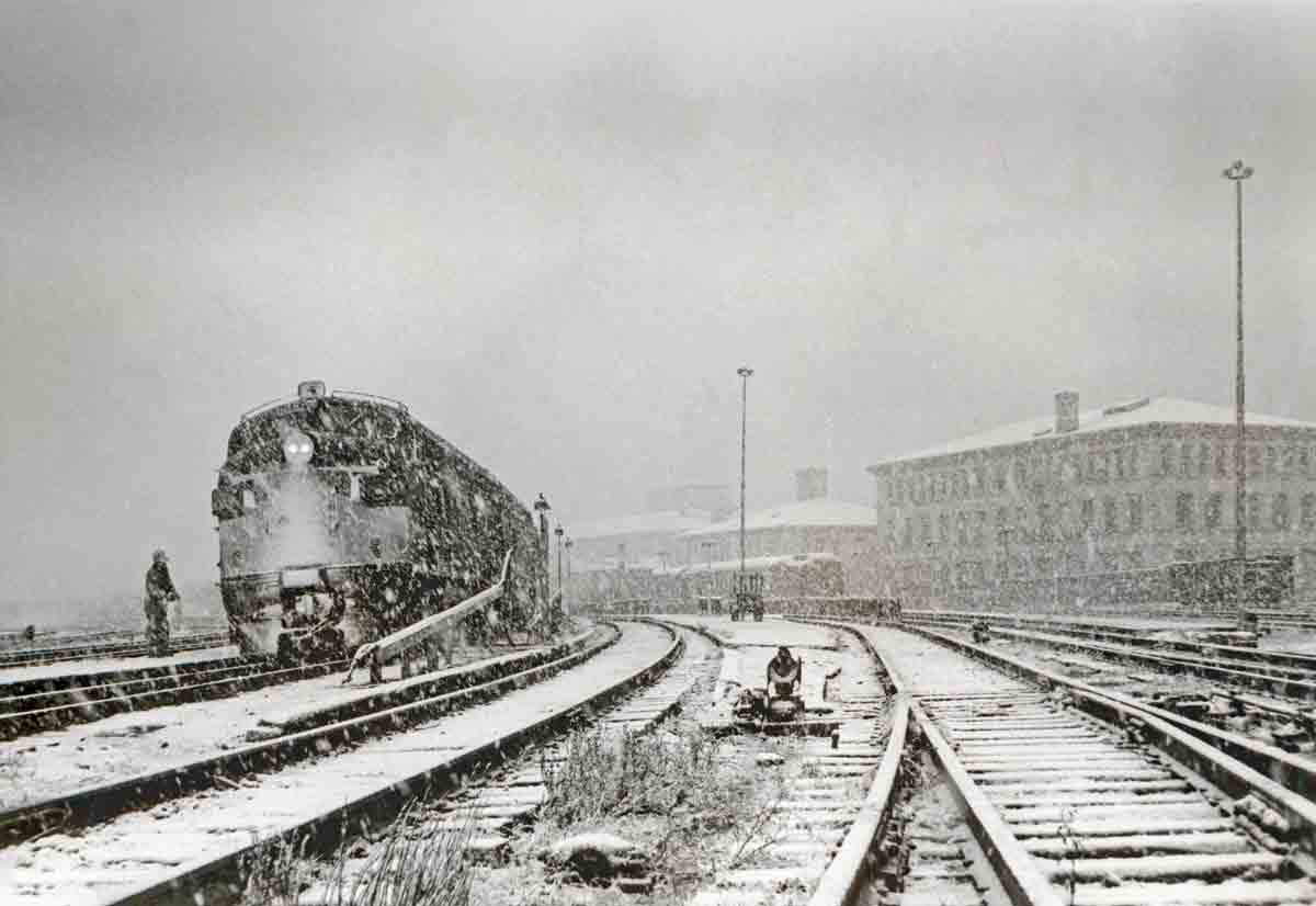 Passenger train in station with heavy snow