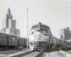 Passenger train in station surrounded by downtown high rises