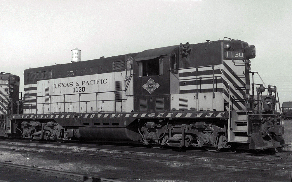 A texas and pacific train sitting on the tracks