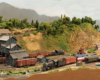 Image of a rural rail yard in a mountainous, arid, verdant landscape with multiple steam locomotives running trains.
