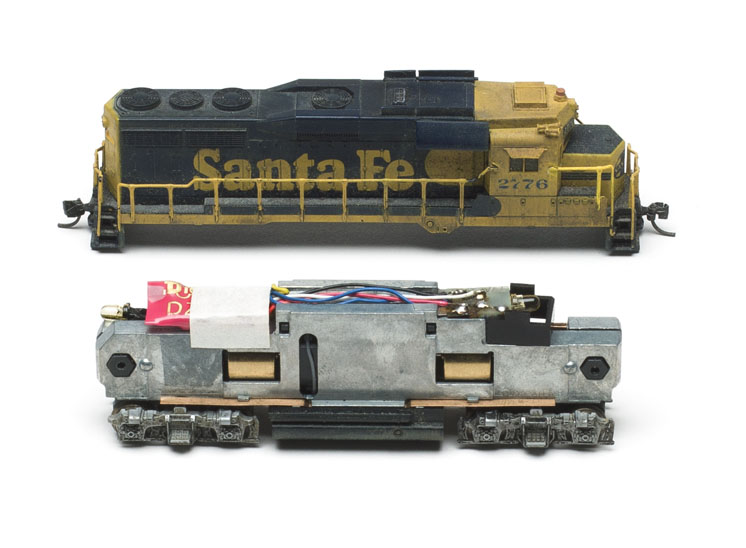 A side profile image of a model locomotive with the shell removed