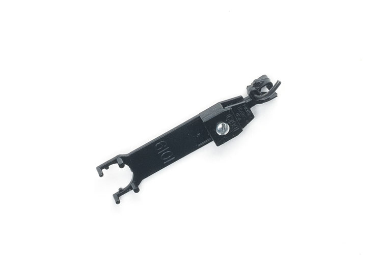 A model freight car coupler detached from the car
