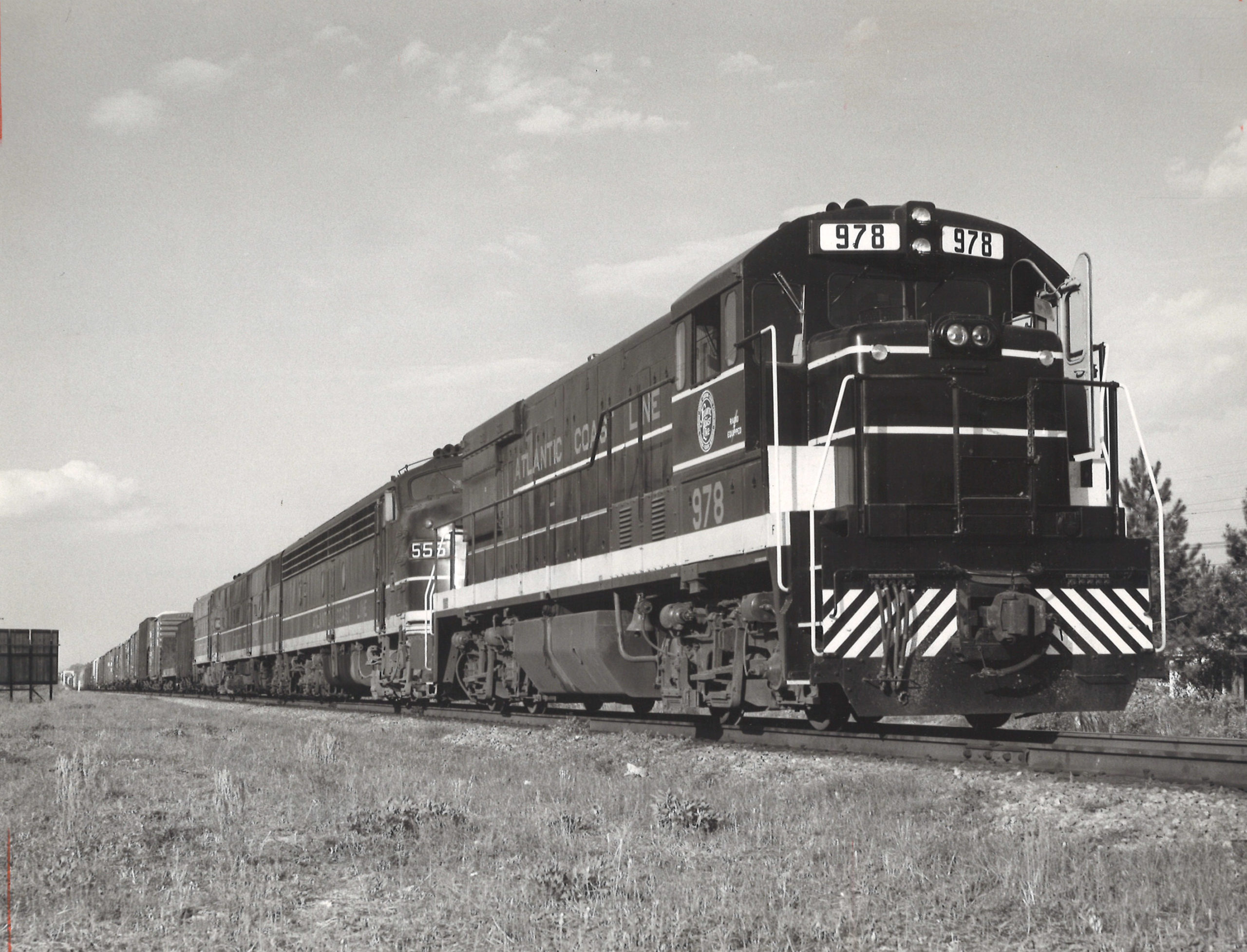A black and white close up photo of a diesel locomotive