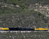 Big boy passing by with mountains in the background