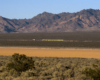 A distant shot of Bog Boy passing by with mountains in the background