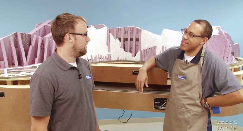 Kent Johnson and Drew Halverson next to layout scenery