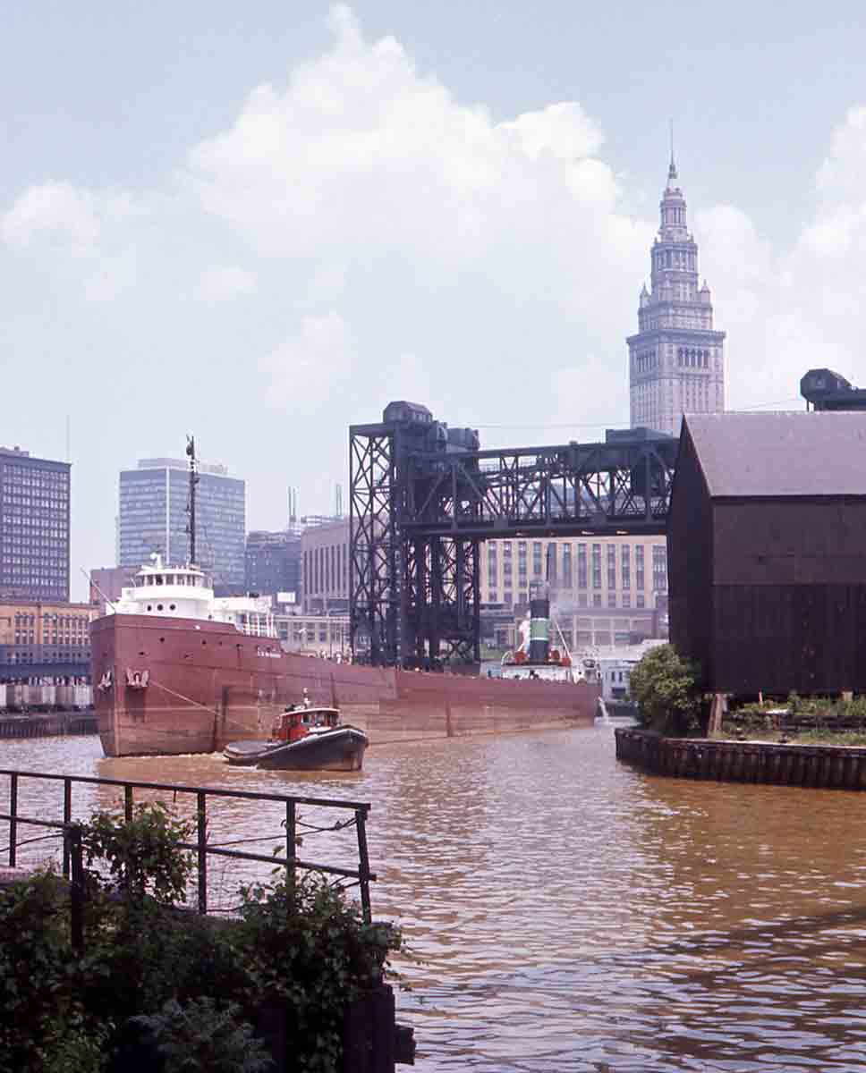Lake boat passing under raised railroad bridge