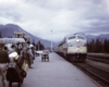 Passengers wait to board diesel powered passenger train