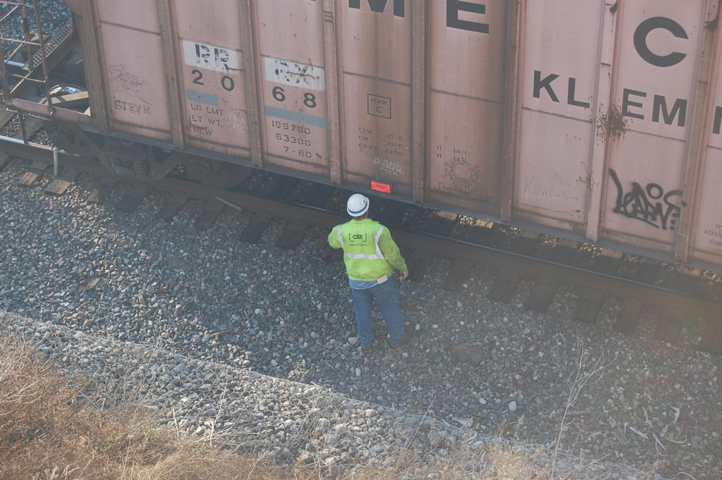 A worker walking up to a storage container