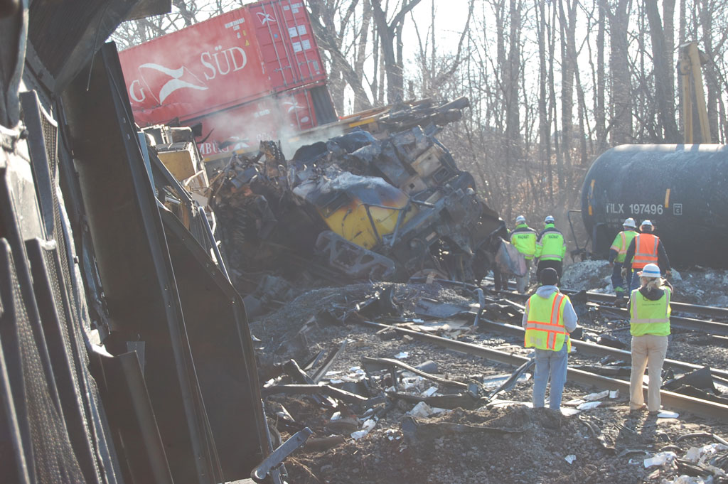 Workers cleaning up a derailed train