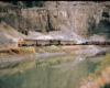 Five diesel locomotives with freight train along river