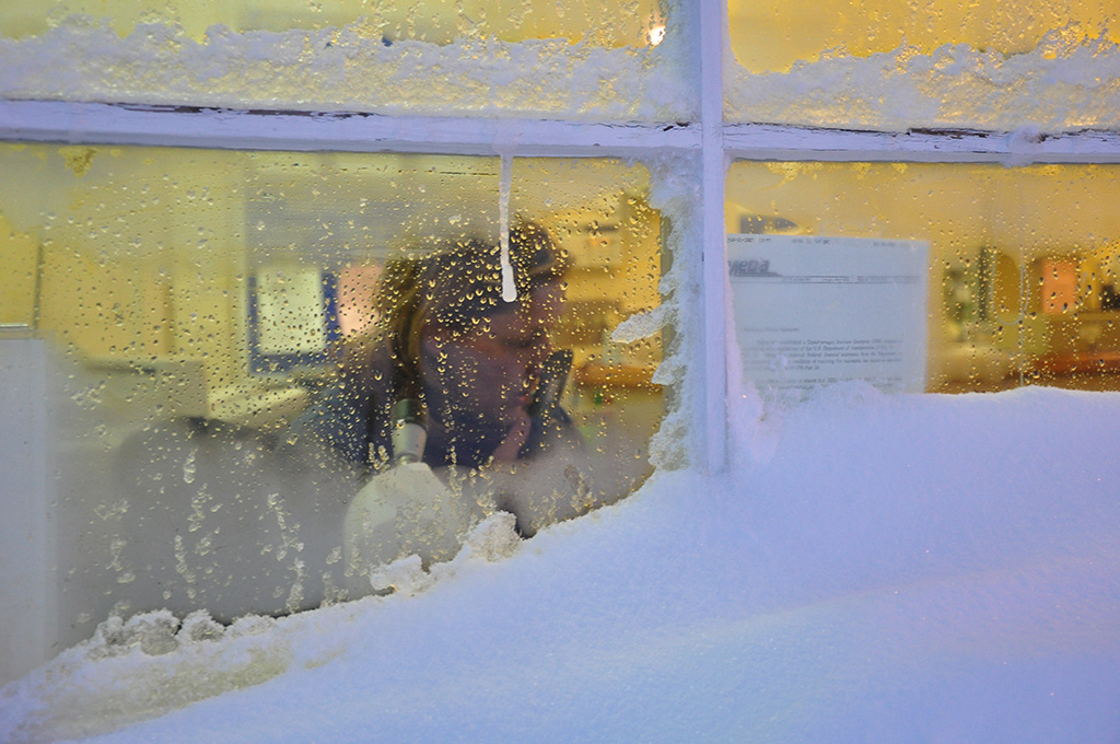 A worker talking on the phone inside a train station