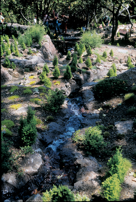 river, rocks, and trees on garden railway
