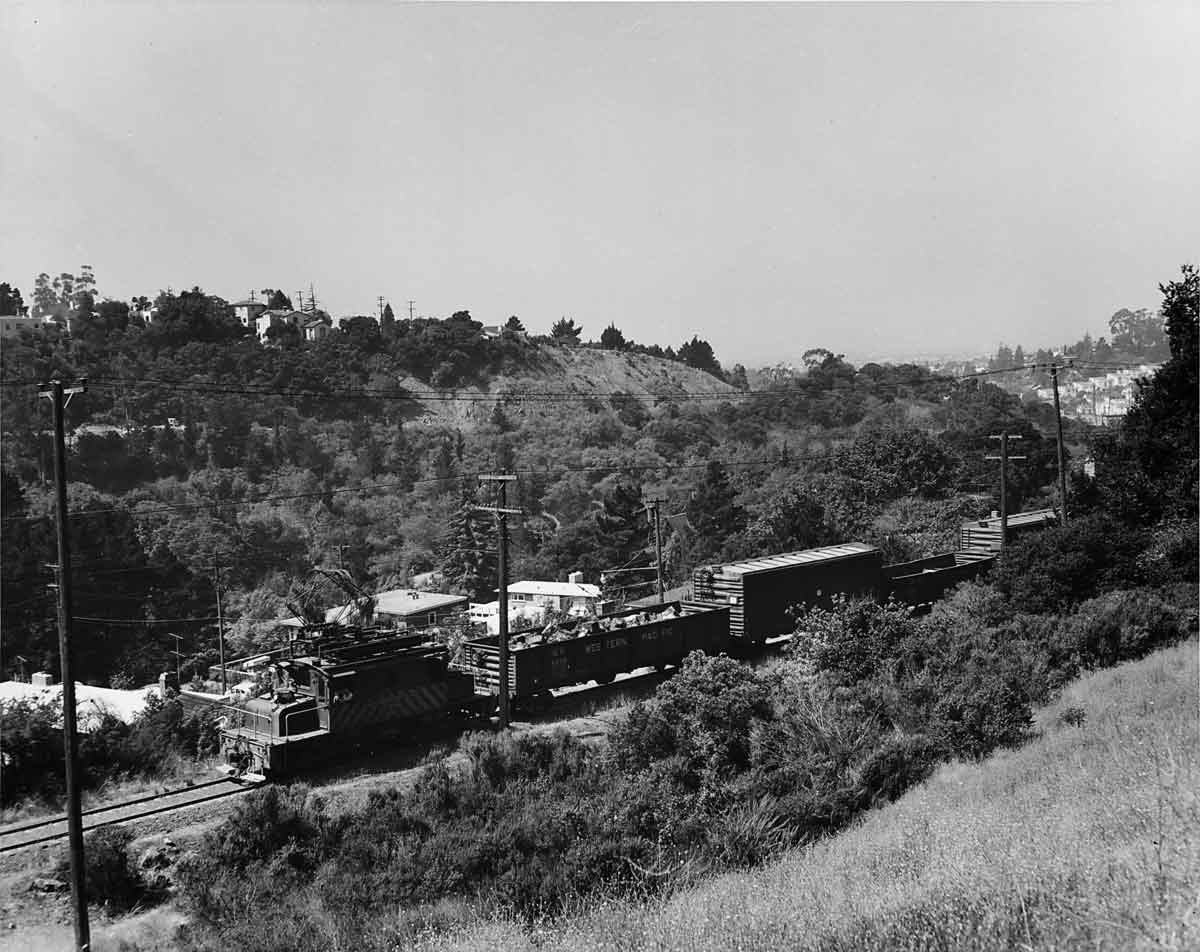 Electric locomotive on freight train in hills