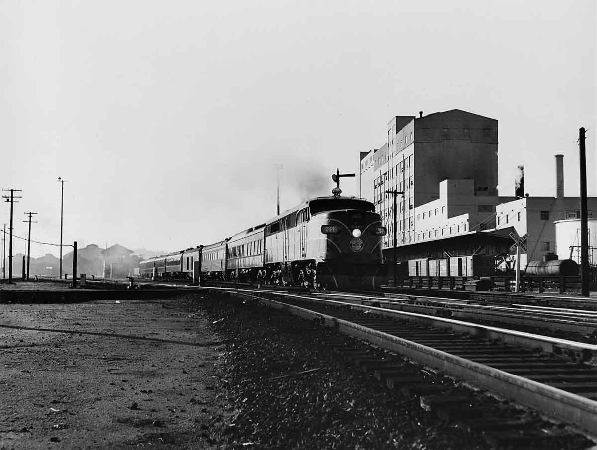 Diesel locomotive on passenger train in city