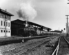 Steam locomotive on long passenger train in curve