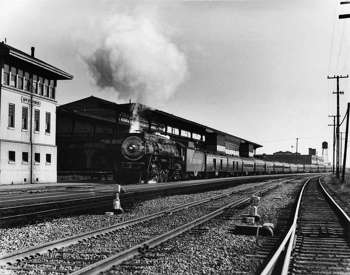 Steam locomotive on long passenger train in curve