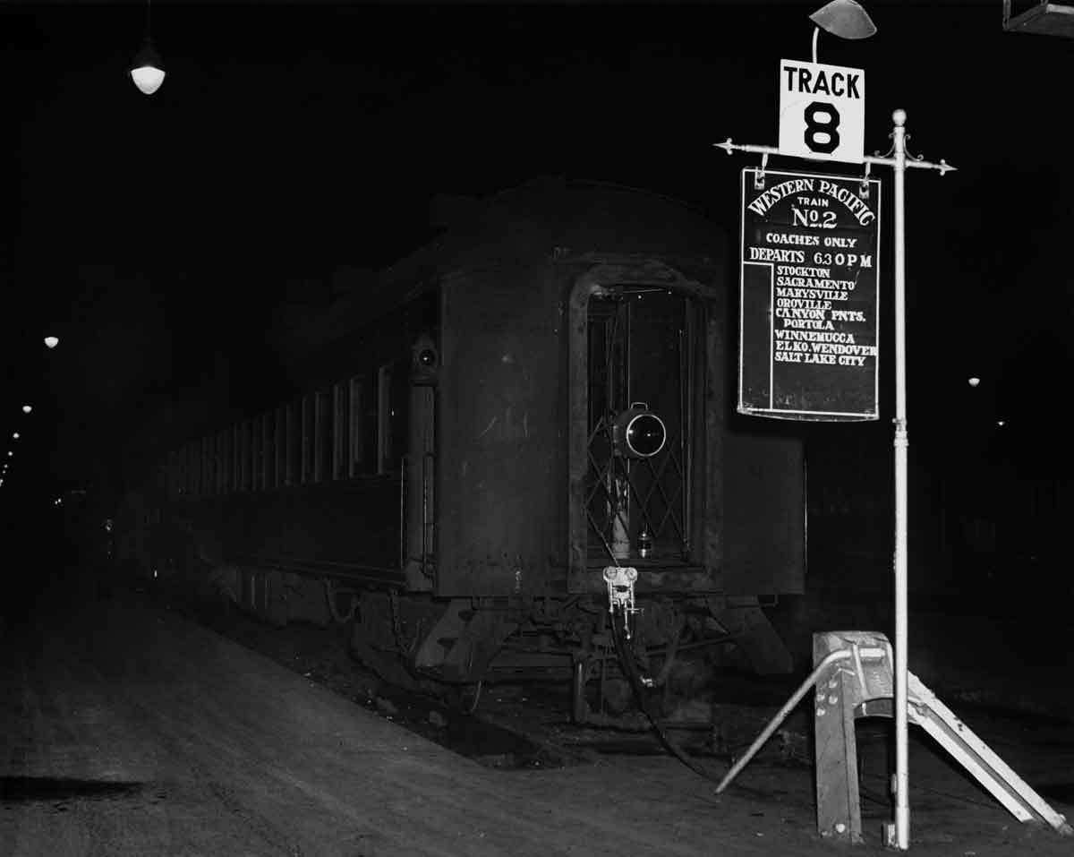 Passenger train in stub end station at night