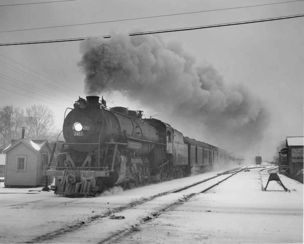 a steam passerger train on a winter day