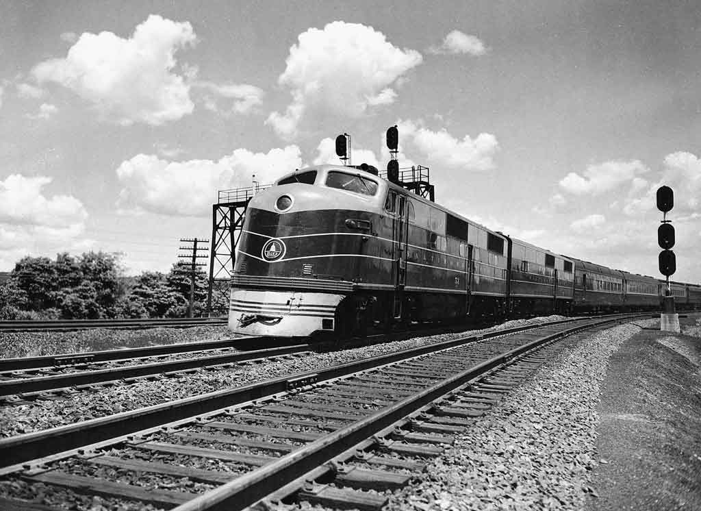 A black and white photo of a locomotive turning a corner