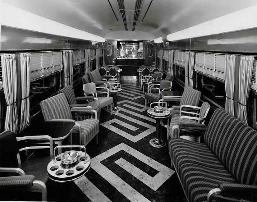 A black and white photo of the inside of an empty buffet car