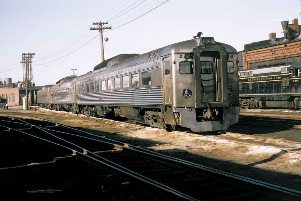 Two trains sitting outside a station