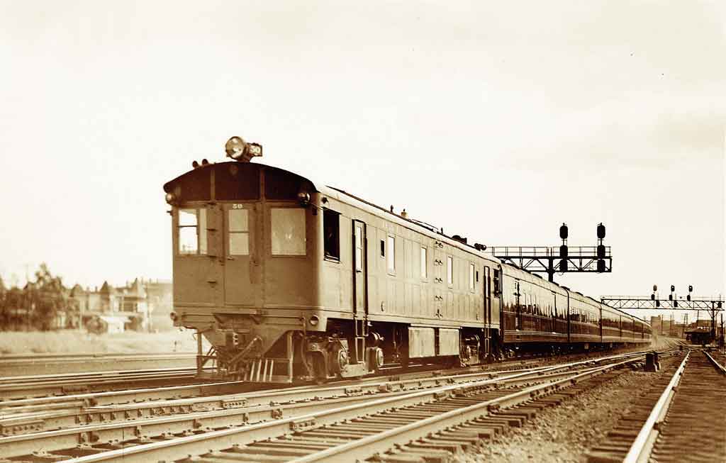 A train passing beneath a stop light