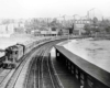 a passenger train passing buildings