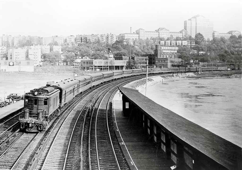 a passenger train passing buildings