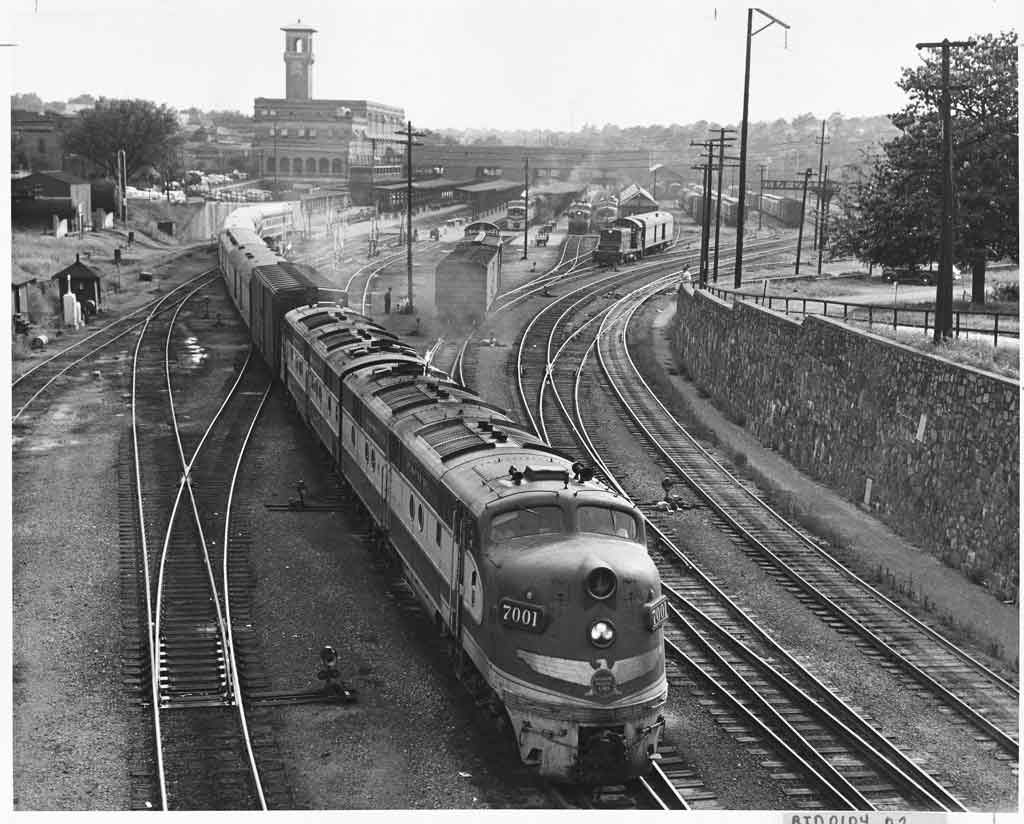 Diesel powered passenger train departs large station