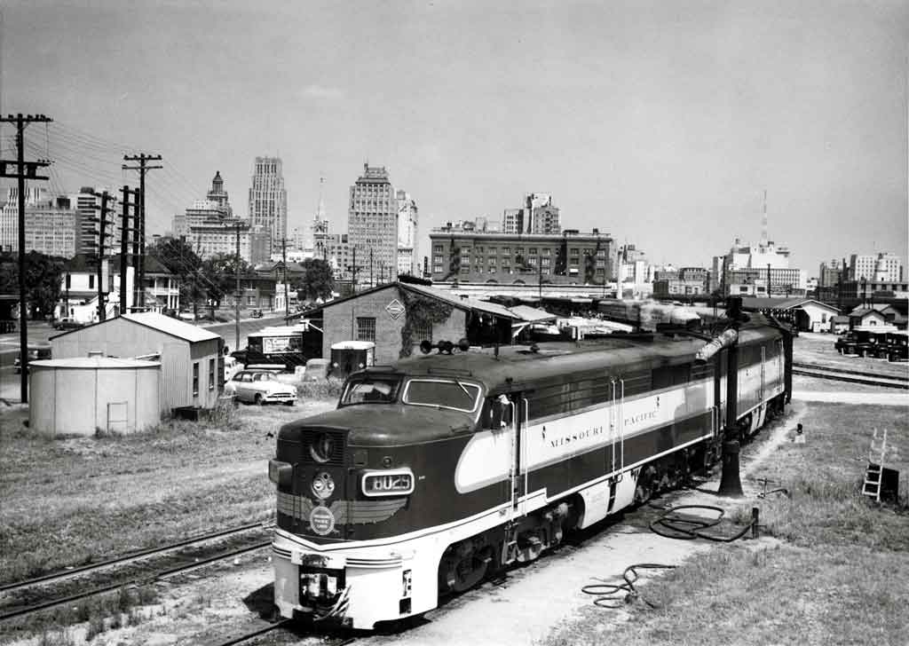 Diesel locomotives with passenger train by water spout
