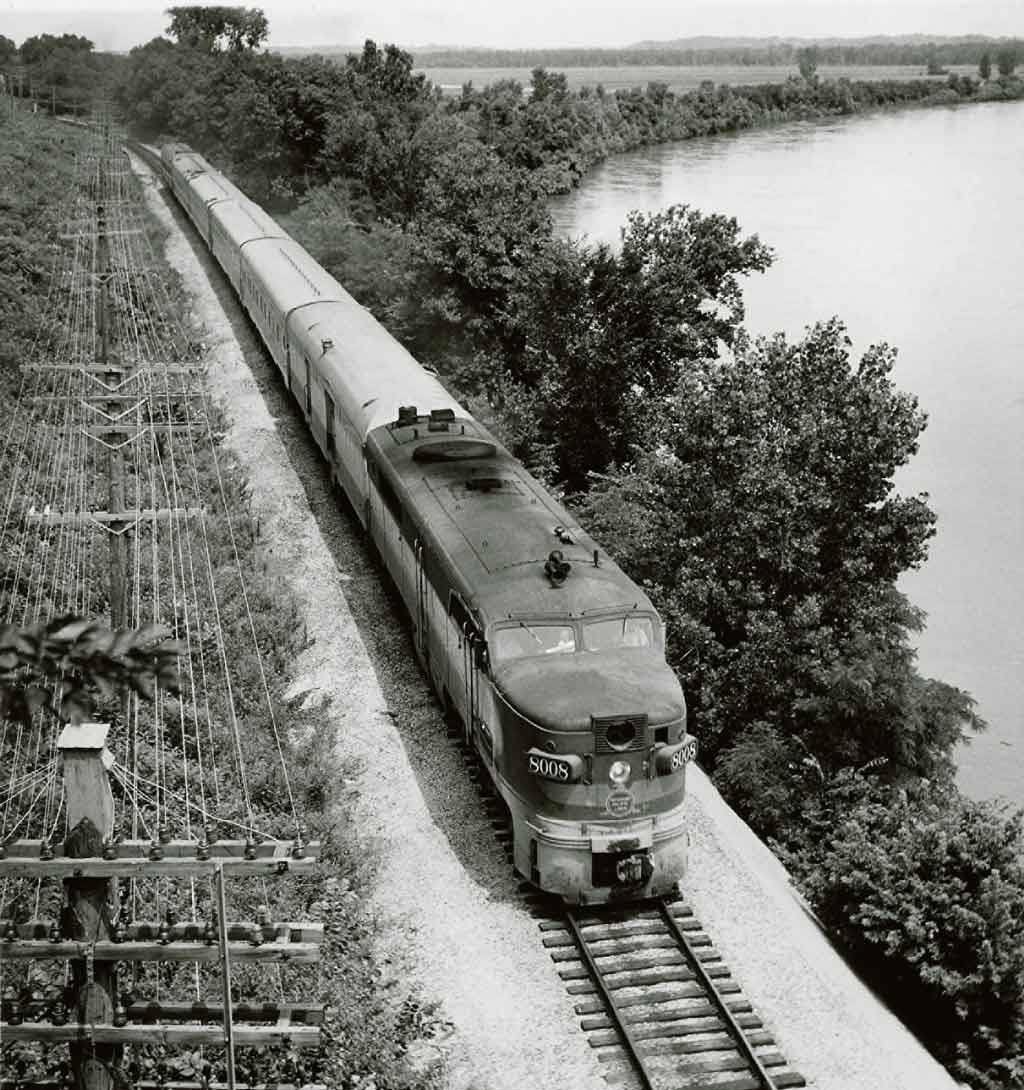 Diesel locomotive with passenger train along river