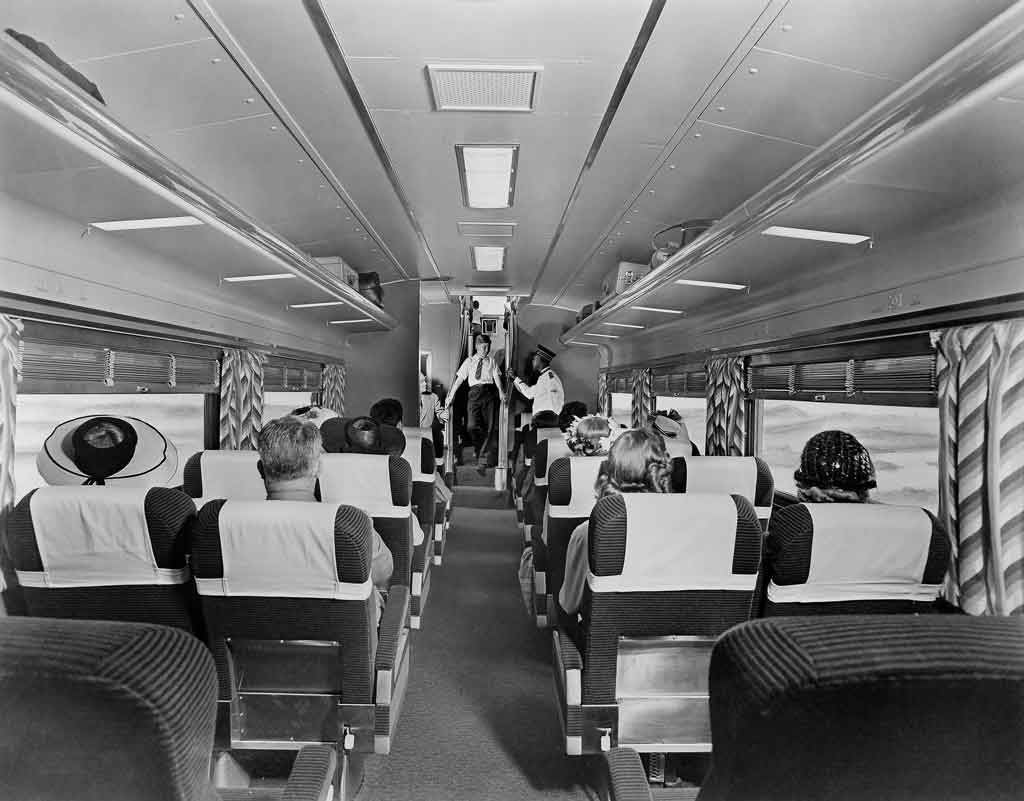 Passengers sit inside coach