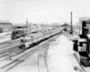 a couple of diesel passenger trains leaving a station