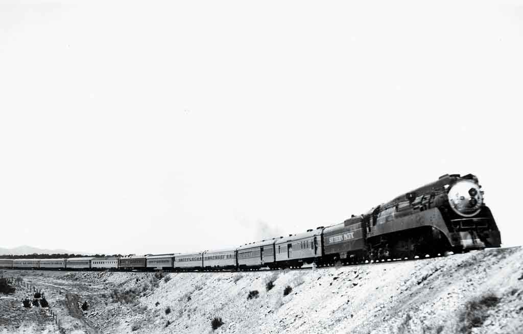 A black and white photo of a locomotive turning a corner